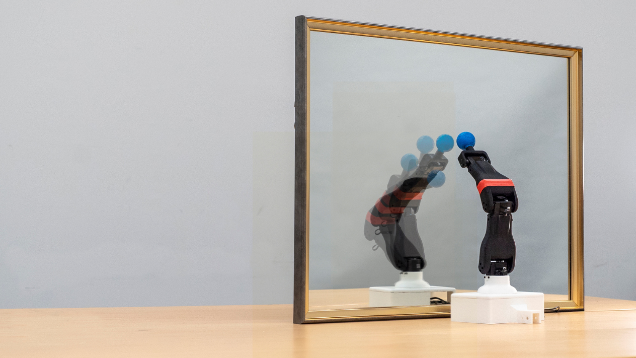 A robot observes its reflection in a mirror, learning its own morphology and kinematics for autonomous self-simulation. The process highlights the intersection of vision-based learning and robotics, where the robot refines its movements and predicts its spatial motion through self-observation. Credit: Jane Nisselson/Columbia Engineering