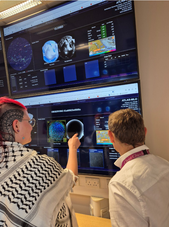 Dr Heloise Stevance and Professor Stephen Smartt with the Asteroid Terrestrial Impact Last Alert System (ATLAS), in the Astrophysics Data Lab, University of Oxford. Credit: Caroline Wood. Credit: Caroline Wood.