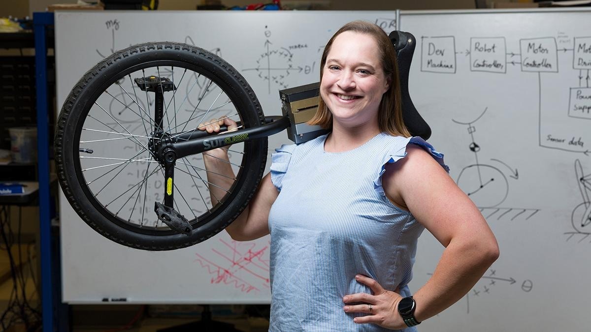 FAMU-FSU College of Engineering Assistant Professor Taylor Higgins poses with her unicycle. Higgins received a National Science Foundation Mind, Machine, and Motor Nexus (M3X) grant to further understanding of human motor learning and its applications in movement-assistive robotic technologies. (Scott Holstein/FAMU-FSU College of Engineering) 